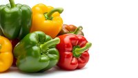 Fresh colorful bell peppers in red, yellow and green isolated on white background for healthy cooking and nutrition concepts.