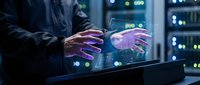 Professional man using holographic display technology with glowing digital interface in modern data center server room for futuristic computing applications.