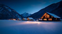 Illuminated wooden chalets in snowy mountain landscape at dusk, cozy winter resort cottages glowing warmly against dramatic peaks and blue hour sky.