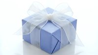 Light blue gift box with elegant white organza bow on white background, perfect for holiday, birthday, and celebration designs.