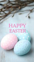 Pastel Easter eggs with polka dot pattern and pink text greeting on rustic wooden background with spring twigs, creating festive holiday atmosphere.