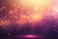 Magical glowing particles floating in purple and gold space atmosphere with bokeh light effects and sparkles creating dreamy cosmic background.