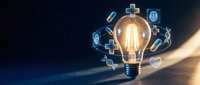 Glowing light bulb with floating medical icons and healthcare symbols representing innovation in medicine and digital health technology solutions.