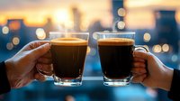 Two hands toasting with dark craft beer glasses against blurred city lights background at sunset, creating atmospheric bokeh effect and celebratory mood.