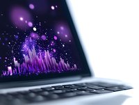 Vibrant purple digital equalizer visualization with glowing particles displayed on laptop screen, creating dynamic music or sound wave representation.