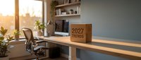 Modern home office workspace with wooden desk, ergonomic chair and 2027 trends sign in warm natural lighting for business planning and productivity.