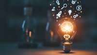 Glowing light bulb with innovation icons floating above representing creative ideas, business solutions, and entrepreneurial thinking for startup concepts.