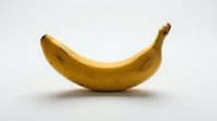 Ripe yellow banana isolated on white background, ready for design use on packaging, menus, nutrition guides, and educational materials.