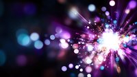 Vibrant explosion of light with purple and blue bokeh effects on dark background, creating dynamic starburst pattern with glowing particles and lens flares.