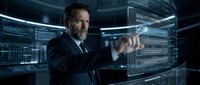 Mature businessman interacting with futuristic holographic interface in high-tech control room with digital displays and blue lighting effects.