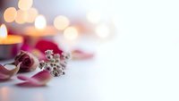 Elegant Christmas ornaments with warm bokeh lights creating festive holiday atmosphere for seasonal decorations and greeting cards.