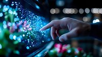 Magical finger touch creating glowing particle effect with blue and pink bokeh lights against dark background. Concept of digital transformation and innovation.