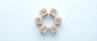 Wooden cubes with engraved contact icons arranged in circle on white background. Business communication symbols for marketing materials and presentations.