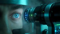 Young man with blue eyes using advanced surveillance or monitoring equipment with glowing digital interface elements for security, technology, and cybersecurity applications.