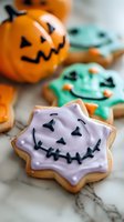 Halloween decorated sugar cookies with spooky faces and orange pumpkin bucket for festive autumn celebration and trick or treat party desserts.