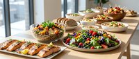 Fresh healthy meal spread with colorful salads, grilled salmon and assorted dishes on wooden table in modern kitchen setting for catering events.