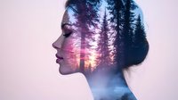 Dreamy double exposure portrait combining female profile silhouette with misty pine forest at sunset, artistic photography blend showing nature within human form.