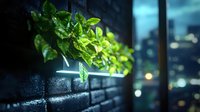 Fresh green leaves growing from dark brick wall with bokeh city lights in background creating urban garden atmosphere at night.