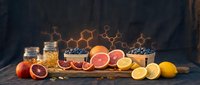 Natural honey jars with fresh citrus fruits and blueberries on rustic wooden table with hexagonal honeycomb pattern background for organic food concepts.
