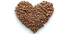 Coffee beans arranged in heart shape on white background, isolated composition for cafe menu, packaging design and coffee shop branding materials.