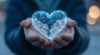 Glowing digital heart shape formed by connected dots and lines floating above cupped hands, symbolizing technology, innovation and care in healthcare sector.