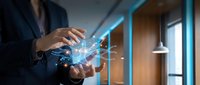 Businessman holding glowing digital network connections with data visualization in modern office environment for technology and innovation concepts.