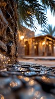 Warm evening lights illuminate palm tree and stone pathway creating cozy tropical atmosphere with golden bokeh effects for hospitality and travel designs.