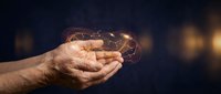 Hands holding glowing light bulb with network connections representing innovation, creativity, and bright ideas for business solutions and technology concepts.