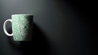 White ceramic mug with green circuit board pattern on dark surface. Tech-themed drinkware for office, programming workspace or electronics enthusiast.
