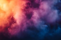 Dramatic colorful smoke clouds in orange, purple and blue creating ethereal atmospheric background with mystical dreamy texture for creative designs.