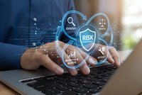 Businessman hands protecting digital risk management icons with identify, monitor, control and legal compliance symbols over laptop keyboard.
