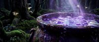 Magical glowing potion bubbling in a wooden cauldron surrounded by mystical forest vegetation and enchanted light particles for fantasy game design and magical storytelling projects.