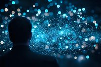 Silhouette of person observing glowing blue bokeh lights and particles against dark background, creating magical atmosphere of wonder and digital transformation.
