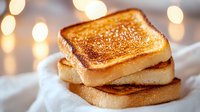 Golden-brown grilled cheese sandwich with melted filling on white cloth, soft bokeh lights in background creating cozy atmosphere. Perfect for food blogs.