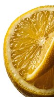 Juicy lemon half close-up showing glistening pulp segments and textured peel on white background, evoking freshness and citrus flavor.