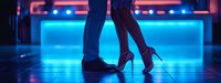 Couple dancing in nightclub with neon blue lights, man in jeans and woman in red high heels on dark dance floor.