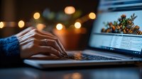 Female hands typing on laptop keyboard in evening with warm bokeh lights and cozy atmosphere, working from home setup for remote work and online business.