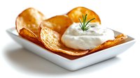 Crispy homemade potato skins topped with creamy sour cream and fresh rosemary garnish served in white ceramic plate on white background, appetizing snack food.