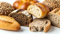 Fresh artisan bread assortment with whole grain, sourdough and brioche loaves isolated on white background for bakery and food design projects.