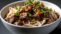 Asian beef noodle bowl with tender meat, fresh herbs, bean sprouts and crushed peanuts in savory sauce for restaurant menu or food blog content.