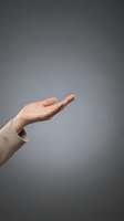 Open palm hand gesture of a woman with fair skin wearing a beige sleeve against neutral gray background, suitable for concepts of offering, support, and presentation.
