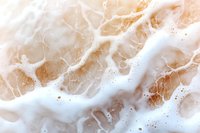 Luxurious beige and white marble texture with natural veining pattern and delicate swirls creates elegant stone surface background for interior design projects.