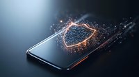 Glowing shield protection symbol emerging from smartphone screen with digital particle effect and orange light trails on dark background. For cybersecurity concepts.