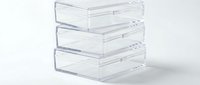 Clear acrylic storage drawers stacked in three tiers for organizing office supplies, cosmetics, or small items in modern minimalist workspace.