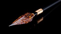 Luxury copper fountain pen nib with intricate engraved patterns on black background for premium writing instruments and calligraphy projects.