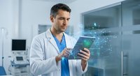 Middle-aged Caucasian male doctor in white coat using tablet with holographic medical network display in modern hospital laboratory setting.