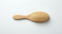 Wooden hairbrush with natural bristles on white background, suitable for hair care, beauty, and wellness product photography and design projects.