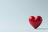 Red glossy heart shape on white background with soft shadow, minimalist romantic composition for Valentine's Day cards and love concepts.