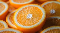 Fresh juicy orange slices arranged in rows showing bright pulp texture and natural citrus segments, creating vibrant healthy food composition for juice packaging design.
