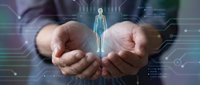 Healthcare professional holding holographic human body model with medical data visualization for telemedicine and digital health technology applications.